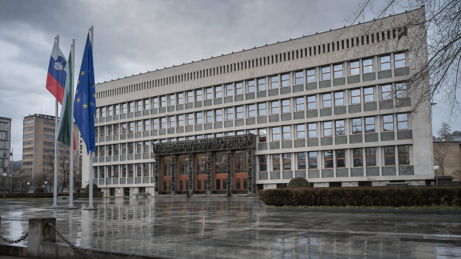 The Slovenian parliament building during cabinet negotiations with papers on a table.