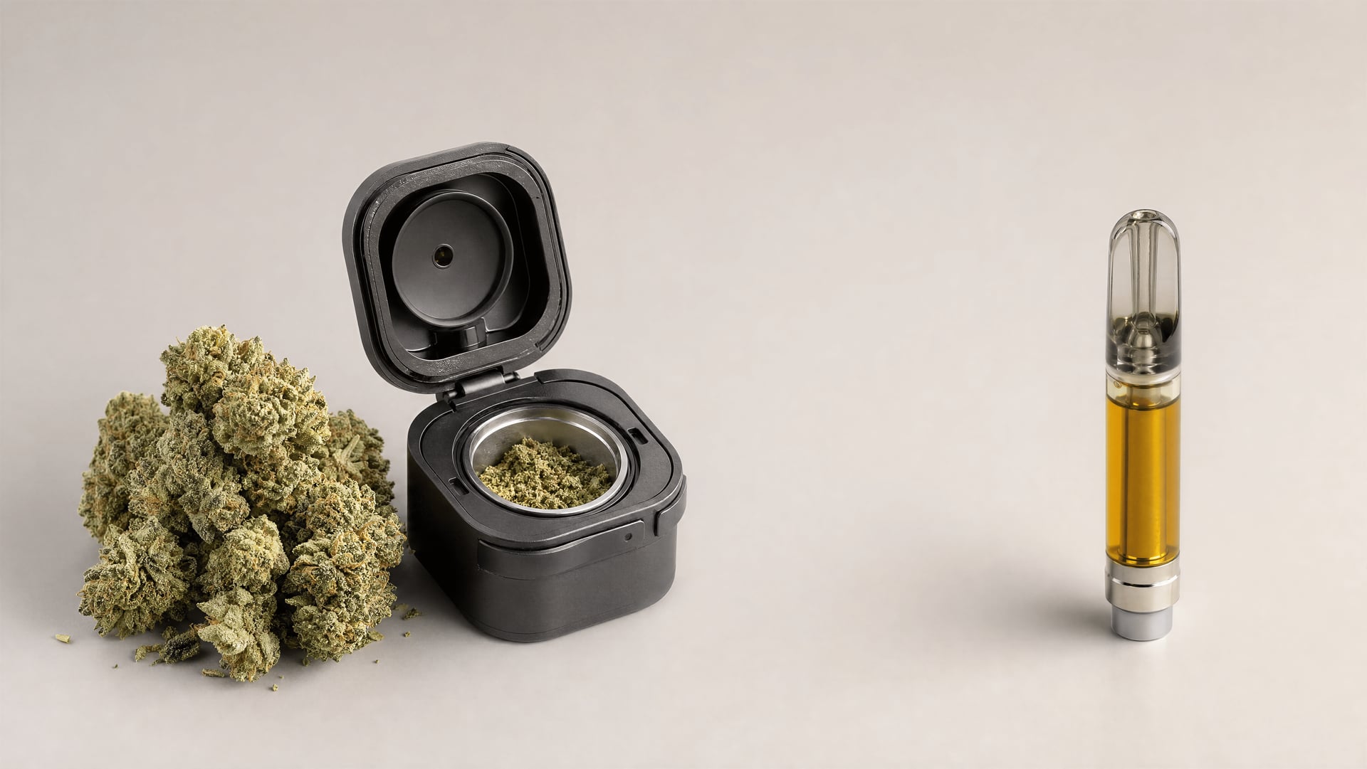 Dry cannabis flower and an open herb chamber on one side, with a separate THC oil cartridge on the other.