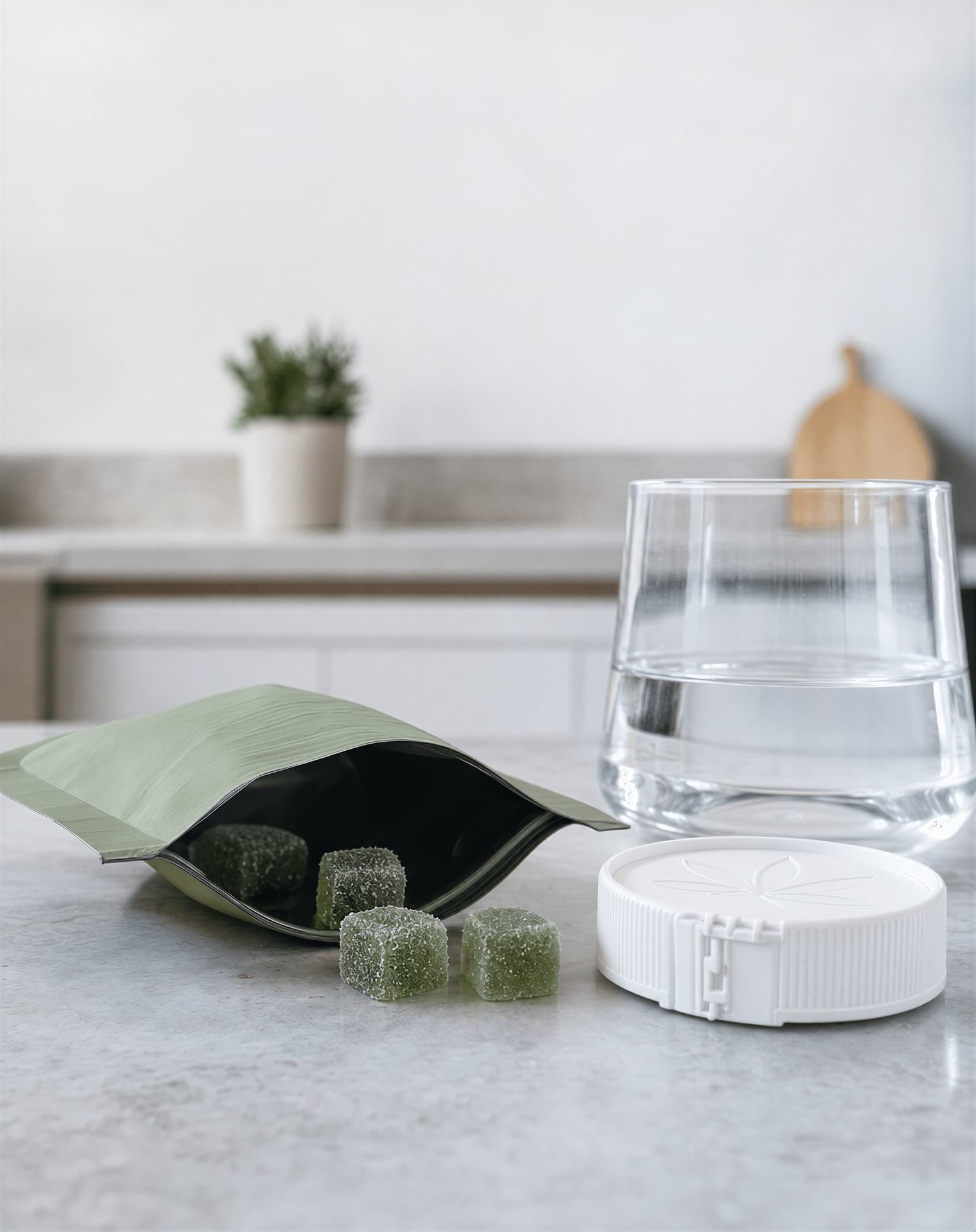 Delta-8 gummies and packaging on a kitchen counter with a child-resistant cap nearby.