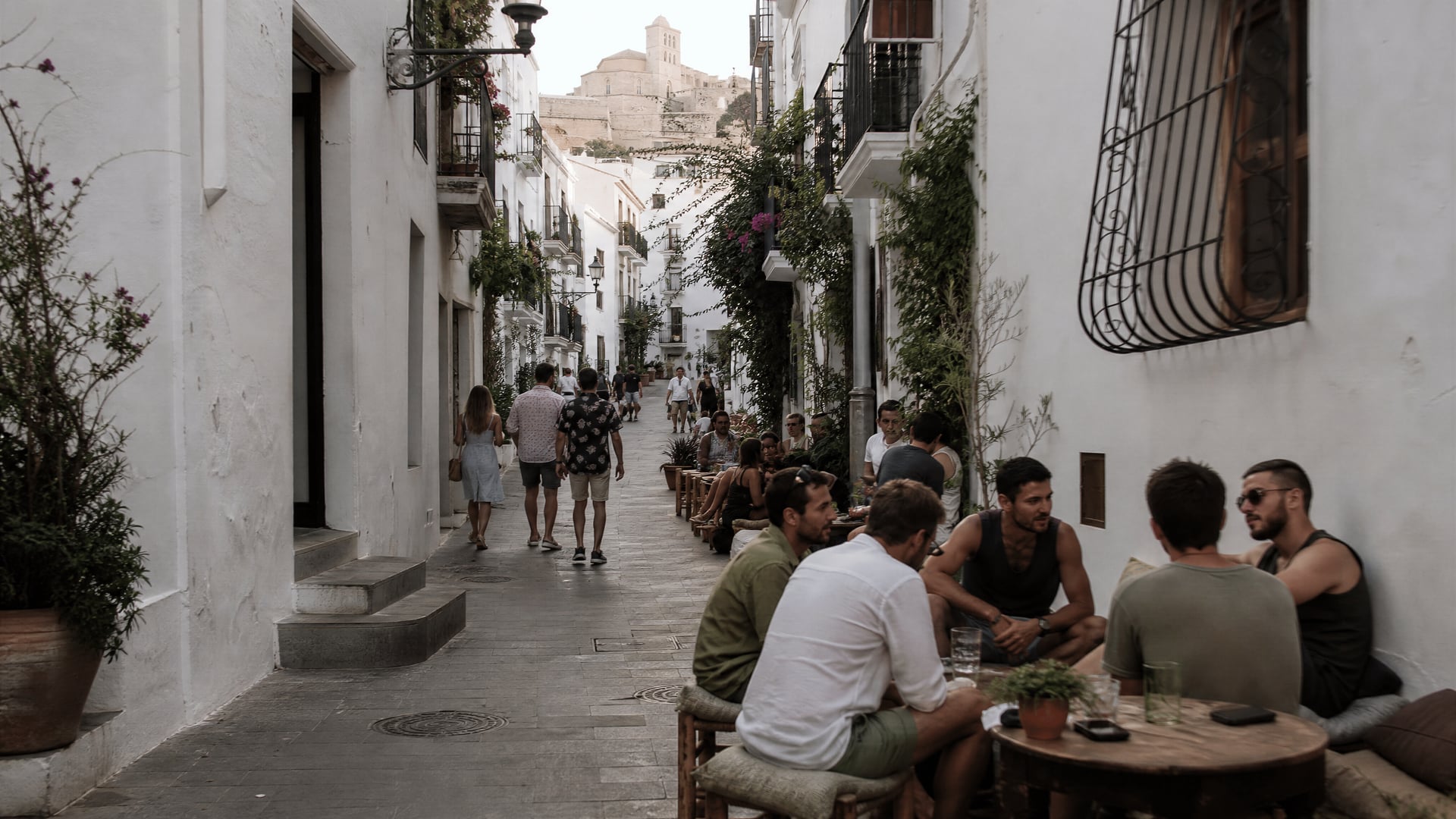 Narrow Dalt Vila lanes in Ibiza with neighborhood life and cannabis club context