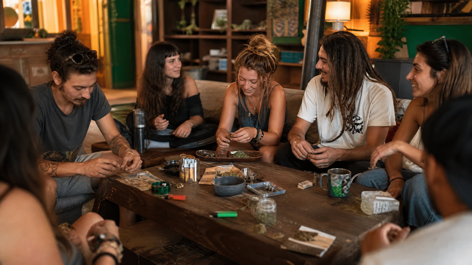 Port de Pollença waterfront promenade with locals and cannabis club context