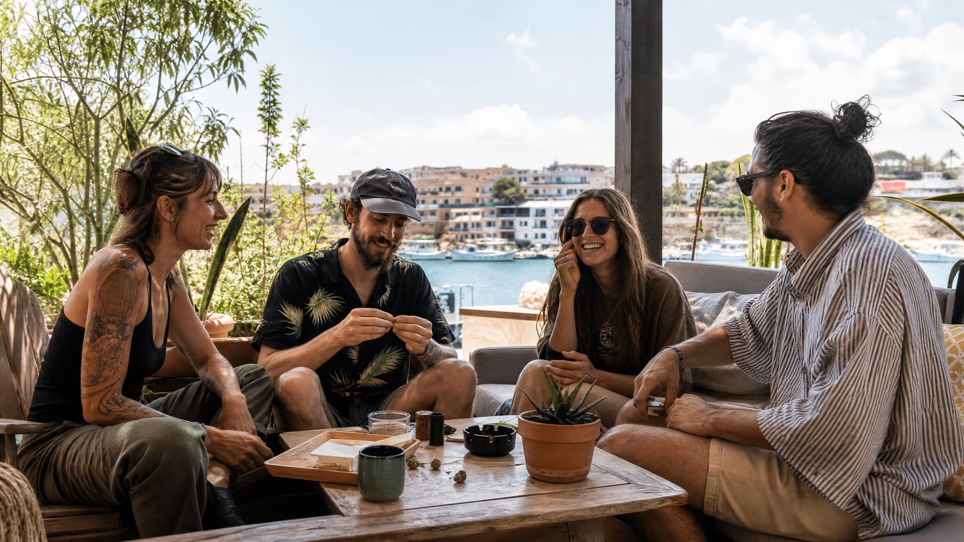 Members sharing conversation at a Porto Cristo cannabis club terrace table