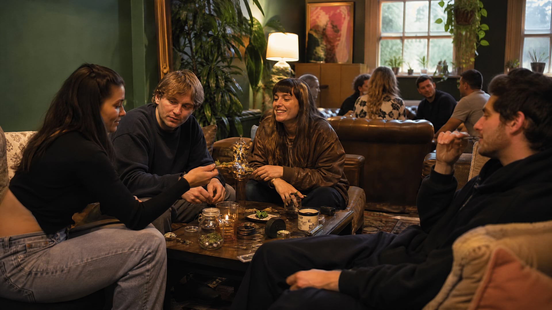 Members-only lounge in Netherlands with sofas, low tables, and cannabis social club atmosphere