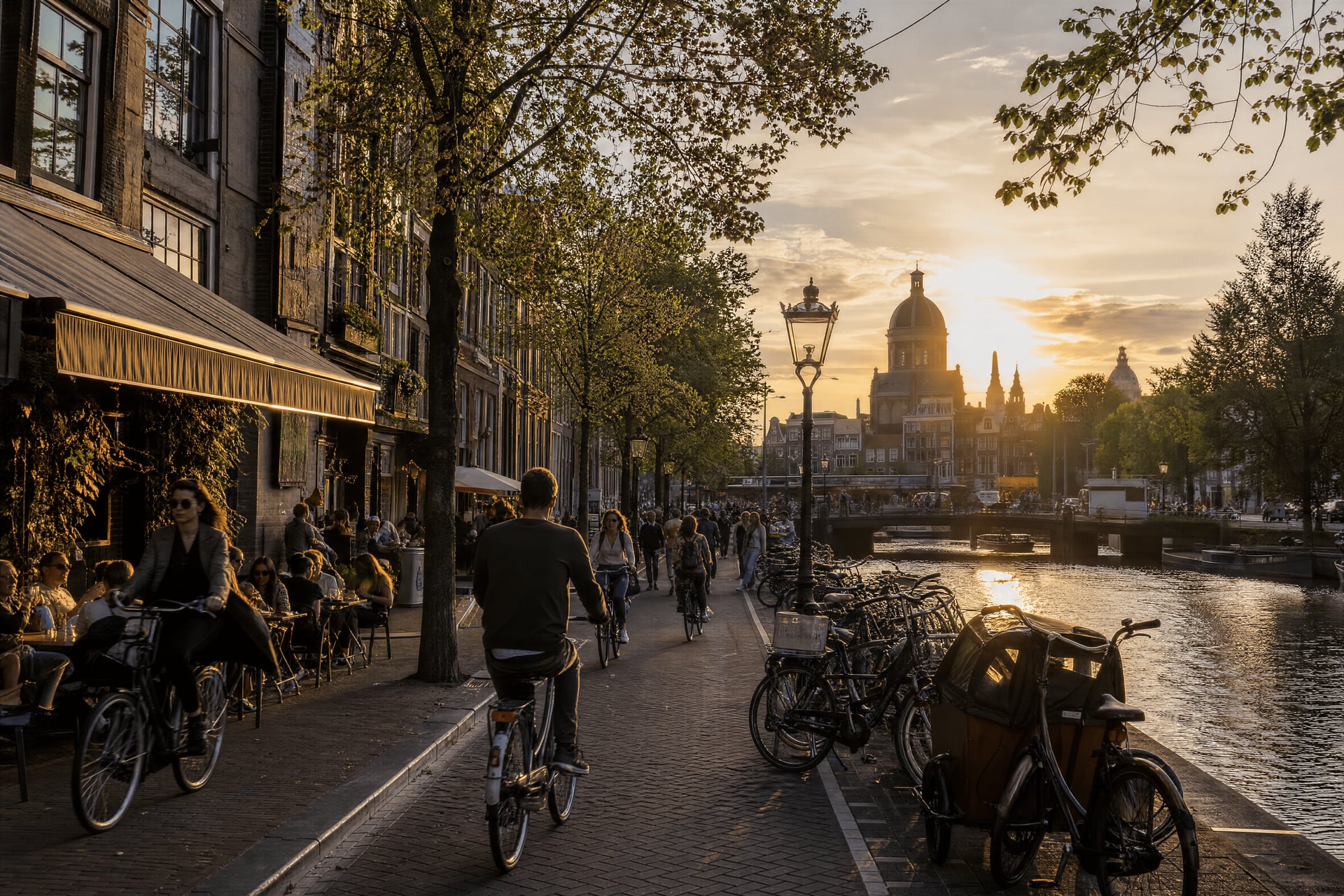 Central Netherlands street life and cannabis social club culture, with cyclists and canal facades