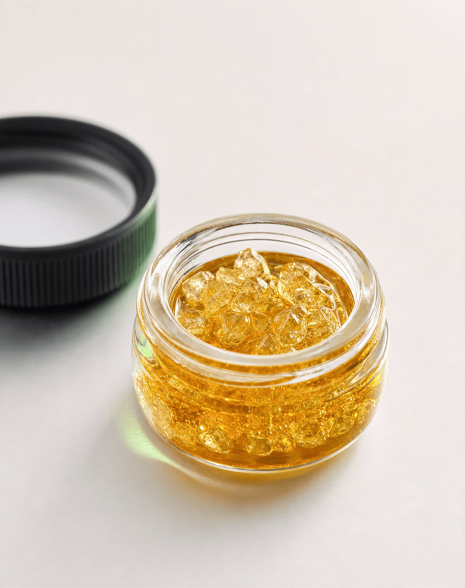 THCA crystals in terpene-rich sauce inside a glass concentrate jar
