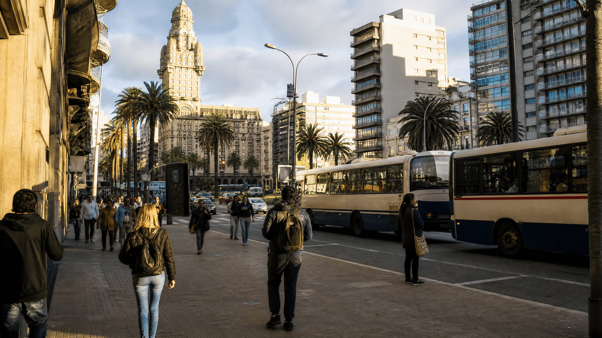 Montevideo boulevard with buses, pedestrians, and neighborhood movement near cannabis clubs