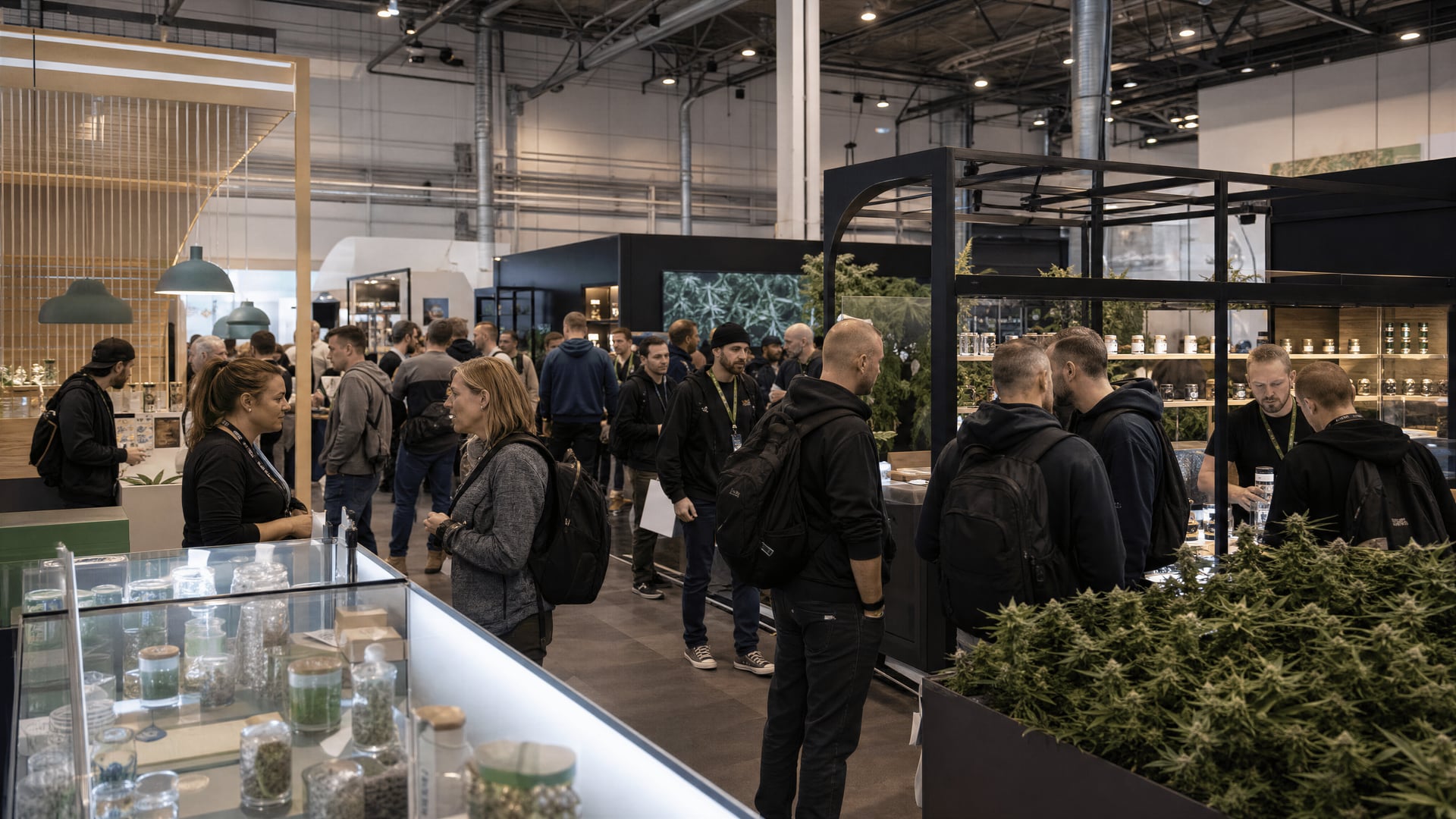 Visitors walking past trade stands and medical cannabis displays inside the Mary Jane Berlin exhibition hall.