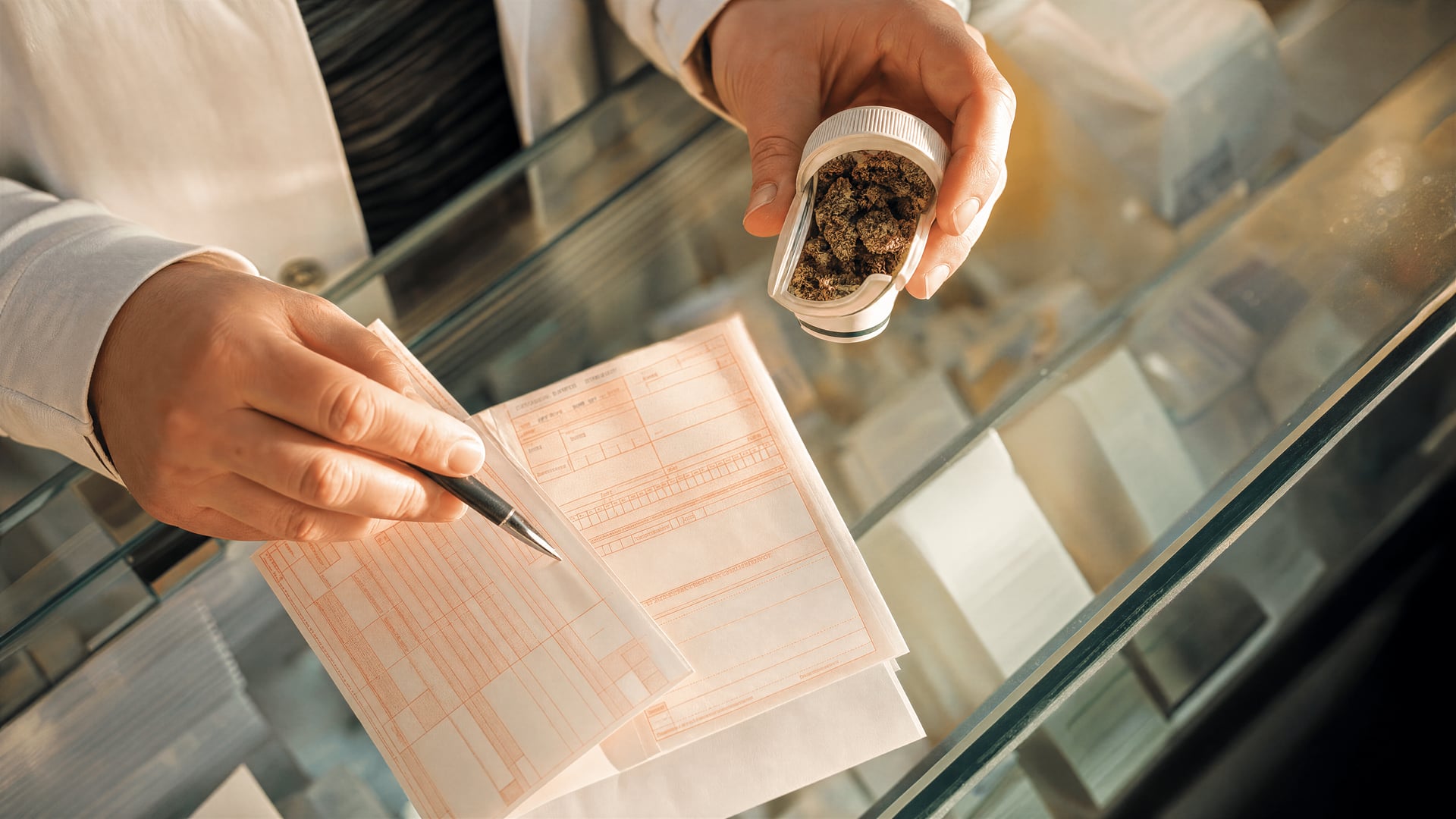 German pharmacy counter with cannabis medicine pricing paperwork and reimbursement forms